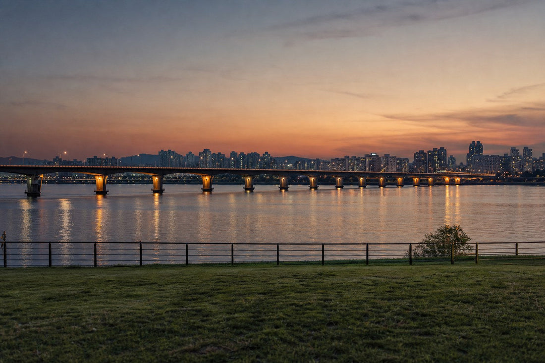 The Han River in Seoul at dusk with a lit bridge