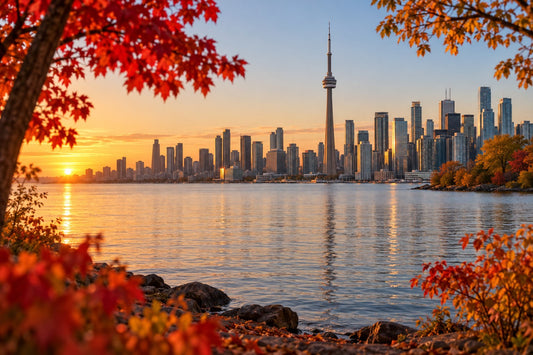 Toronto skyline across Lake Ontario with autumn maple leaves